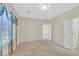This bedroom features neutral carpet, an ample source of light, and an interior door to another area of the property at 6064 Isola Peak Ave, Las Vegas, NV 89122