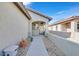 Inviting entryway with an arched doorway and desert landscaping with mature cacti at 6064 Isola Peak Ave, Las Vegas, NV 89122