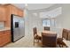 Eat-in kitchen featuring stainless steel appliances, tile flooring, and wooden cabinets at 6064 Isola Peak Ave, Las Vegas, NV 89122