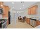 Modern kitchen with stainless steel appliances, wooden cabinets, and an eat-in area at 6064 Isola Peak Ave, Las Vegas, NV 89122