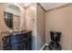 Bathroom features a stylish vanity with a black countertop and matching black toilet at 6141 Babson Ave, Las Vegas, NV 89110