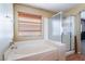 Bright bathroom featuring a soaking tub and separate glass-enclosed shower, perfect for relaxation at 6141 Babson Ave, Las Vegas, NV 89110