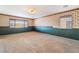 Large bedroom with neutral carpet, two windows, and baseboard trim at 6141 Babson Ave, Las Vegas, NV 89110