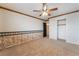 Bright bedroom featuring neutral carpet, a ceiling fan, and a closet with ample storage space at 6141 Babson Ave, Las Vegas, NV 89110