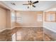 Open bonus room with tile floors, ample natural light, and a ceiling fan at 6141 Babson Ave, Las Vegas, NV 89110
