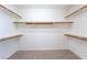Walk-in closet featuring carpeted floors and wooden shelving for optimal organization at 6141 Babson Ave, Las Vegas, NV 89110