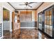 The dining area has eye-catching flooring, a ceiling fan, and double doors to the backyard at 6141 Babson Ave, Las Vegas, NV 89110