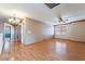A brightly lit hallway with beautiful laminate wood flooring with doors to other rooms at 6141 Babson Ave, Las Vegas, NV 89110