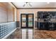 View of the kitchen leads to the backyard, has stainless appliances, dark cabinetry, and granite countertop at 6141 Babson Ave, Las Vegas, NV 89110