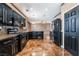The kitchen features black appliances, granite countertops, ample cabinet space, and unique backsplash at 6141 Babson Ave, Las Vegas, NV 89110
