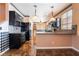Stylish kitchen with black cabinetry, granite countertops, and stainless steel appliances at 6141 Babson Ave, Las Vegas, NV 89110