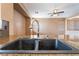 The kitchen sink features granite countertops, a modern faucet, and ample cabinet space at 6141 Babson Ave, Las Vegas, NV 89110