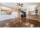 Open living space with tile floors connecting to the kitchen and stairway at 6141 Babson Ave, Las Vegas, NV 89110