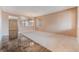 Spacious living room featuring neutral carpet, paint, and a modern light fixture at 6141 Babson Ave, Las Vegas, NV 89110