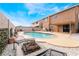 Expansive backyard with a refreshing pool, a fire pit, and comfortable seating for entertainment at 6141 Babson Ave, Las Vegas, NV 89110