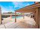 Inviting backyard pool area with a covered patio, built-in grill, and serene landscaping at 6141 Babson Ave, Las Vegas, NV 89110