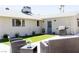 Inviting backyard with a patio, outdoor seating, and a lush artificial grass lawn at 6198 Pinewood Ave, Las Vegas, NV 89103