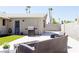 Outdoor patio with seating and a grill, complemented by an artificial grass lawn at 6198 Pinewood Ave, Las Vegas, NV 89103
