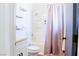 Bright bathroom featuring a shower-tub combination and modern vanity with decorative floating shelves at 6198 Pinewood Ave, Las Vegas, NV 89103