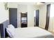 Comfortable bedroom with a large bed, modern decor, and access to an ensuite bathroom at 6198 Pinewood Ave, Las Vegas, NV 89103
