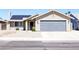 Charming single-story home featuring a well-manicured gravel yard and a two-car garage at 6198 Pinewood Ave, Las Vegas, NV 89103