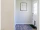 Hallway with stylish wood flooring and decor near a white front door with glass panels at 6198 Pinewood Ave, Las Vegas, NV 89103