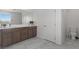 Bathroom with tiled floor, wood vanity, and toilet with a window at 6955 Elysian Valley Ave, Las Vegas, NV 89113