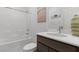 Clean bathroom features a shower-tub combo and single sink vanity with art at 6955 Elysian Valley Ave, Las Vegas, NV 89113
