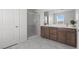 Bathroom with tiled floor, double sink vanity with a glass shower at 6955 Elysian Valley Ave, Las Vegas, NV 89113