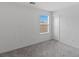 A simple bedroom with a window and carpeted floor creating a cozy space at 6955 Elysian Valley Ave, Las Vegas, NV 89113