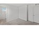 A bright bedroom with a window and closet with neutral carpeting at 6955 Elysian Valley Ave, Las Vegas, NV 89113