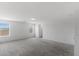 Large bonus room with natural light featuring neutral walls and gray carpeting at 6955 Elysian Valley Ave, Las Vegas, NV 89113