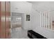 Bright foyer with tiled floor, staircase with white railing, and view into an expansive living room at 6955 Elysian Valley Ave, Las Vegas, NV 89113
