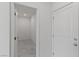 Hallway leading to tiled room with a white door on the right at 6955 Elysian Valley Ave, Las Vegas, NV 89113