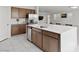 Kitchen island featuring a sink, stainless steel dishwasher, and sleek white countertops at 6955 Elysian Valley Ave, Las Vegas, NV 89113