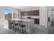 Modern kitchen with white countertops, dark wood cabinets, stainless steel appliances, and breakfast bar at 6955 Elysian Valley Ave, Las Vegas, NV 89113