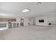 Bright, open living room and kitchen with island, featuring neutral tones and modern lighting at 6955 Elysian Valley Ave, Las Vegas, NV 89113