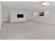 Spacious living room with plush carpeting, white walls, and three large windows at 6955 Elysian Valley Ave, Las Vegas, NV 89113