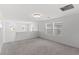 Open loft featuring a modern lighting fixture and natural light from multiple windows at 6955 Elysian Valley Ave, Las Vegas, NV 89113