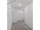 Walk-in closet with shelving for optimal storage and neutral carpet at 6955 Elysian Valley Ave, Las Vegas, NV 89113