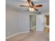 Bedroom with carpet, ceiling fan, and doorway to the bathroom at 698 S Racetrack Rd # 114, Henderson, NV 89015