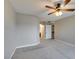 Neutral bedroom with a ceiling fan and carpeted floors leading to a bathroom at 698 S Racetrack Rd # 114, Henderson, NV 89015