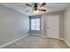 Bedroom featuring carpet, a ceiling fan and large window for natural light at 698 S Racetrack Rd # 114, Henderson, NV 89015