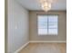 Dining room featuring a modern chandelier, window, and wood-look floors at 698 S Racetrack Rd # 114, Henderson, NV 89015