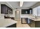 Updated kitchen with stainless steel appliances, quartz countertops, and dark wood cabinets at 698 S Racetrack Rd # 114, Henderson, NV 89015