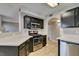Modern kitchen featuring stainless steel appliances, dark wood cabinets, and light countertops at 698 S Racetrack Rd # 114, Henderson, NV 89015