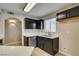 Kitchen showcasing stainless steel dishwasher, sink, quartz countertops, and wood flooring at 698 S Racetrack Rd # 114, Henderson, NV 89015