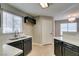 Bright kitchen with stainless steel sink, modern faucet, quartz countertops, and wood flooring at 698 S Racetrack Rd # 114, Henderson, NV 89015