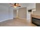 A spacious living room featuring an electric ceiling fan and a tiled fireplace at 698 S Racetrack Rd # 114, Henderson, NV 89015