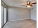 A spacious living room featuring an electric ceiling fan and a sliding glass door at 698 S Racetrack Rd # 114, Henderson, NV 89015